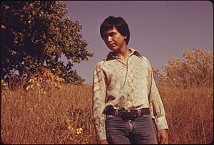 RON MCKINNEY, 22, WHOSE INDIAN NAME IS MAHKUK, IS STANDING IN A VIRGIN TALLGRASS PRAIRIE AREA NEAR WHITE CLOUD AND... - NARA - 557112