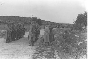 A DETACHMENT OF THE JEWISH SUPERNUMERARY POLICE, UNDER THE COMMAND OF MOSHE DAYAN, LINING UP AT THE ESTABLISHMENT SITE OF KIBBUTZ HANITA IN THE WESTER