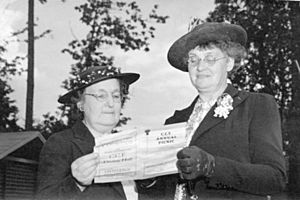 Mrs. Susie Lane Clark and Alderwoman Helena Gutteridge examining a C.C.F. annual picnic brochure