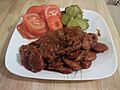 Persian Port Sausage (Sosis Bandari) with sliced tomato and kosher dills
