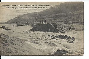 Postcard view of breaking the dam of the Cape Cod Canal, July 1914