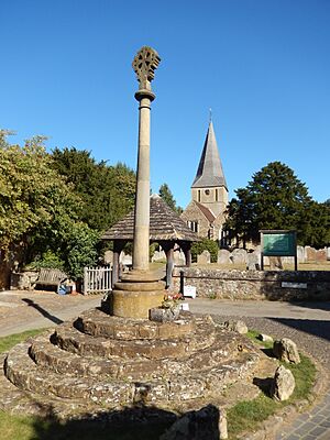 Shere war memorial with St James in the background