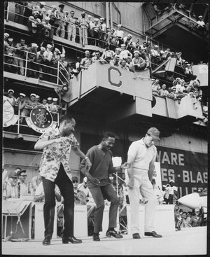 Hollywood comedian Bob Hope joins dancers Harold and Fayard Nicholas in a dance step aboard the U.S. aircraft carrier Ti - NARA - 541852