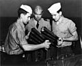 Jack Dempsey with USCG sailors loading weapon cph.3b08434