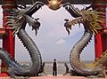 A visitor of Sanggar Agung Temple toke a picture under the dragon statues, Surabaya-Indonesia