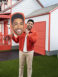 Jake from State Farm holding his own head in the State Farm Gamerhood Challenge 2 Neighborhood