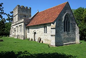 A view of the exterior of the church from the south east - a white-coloured chancel with red tiles, a square perpendicular nave and a stocky tower with large embattlements.