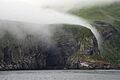 Coastal view of Chagulak Island in Alaska with fog in the horizon
