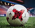 Football made of sewn together X shaped panels with a painted stylized small X in the middle of the panel. Also Printed on the ball is the name and logo for both Adidas and confederation cup 2017.