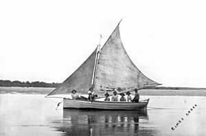 Seven lads in a boat at Eimeo Creek, Mackay region