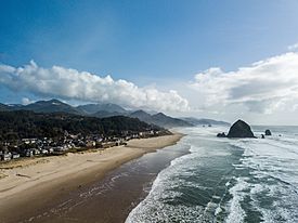An aerial view of Cannon Beach with Haystack Rock in the background.