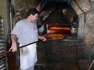Pizza baking in brick oven, New Haven