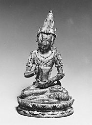 Seated Male Deity Holding a Cuirass (Chest Armour) last quarter of the 10th–first half of the 11th century