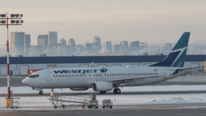 WestJet 737-800 in front of Calgary skyline (Quintin Soloviev)