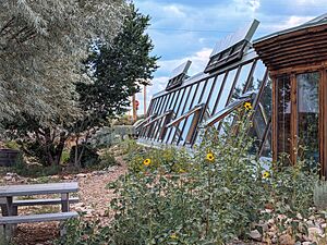 Earthship Windows, Water Barrels, and Solar Panels