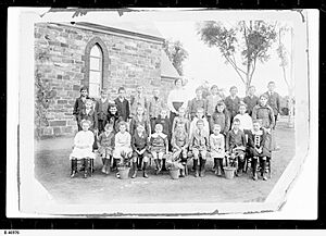 Pupils and teachers in a group view outside Australia Plains School, 1921
