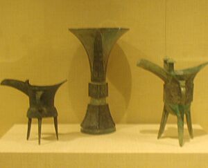 Shang Dynasty bronzes, one vase and two tripods