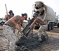 US Navy 070515-N-0938M-005 Seabees attached to Naval Mobile Construction Battalion (NMCB) 133 pour concrete into a concrete pad located inside the expansion area of Camp Lemonier