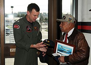 US Navy 100116-N-9860Y-003 Cmdr. Mark Hamilton, commanding officer of the Grey Knights of Patrol Squadron (VP) 46, presents a command photo and ball cap to retired U.S. Air Force Lt. Col. William Holloman III.jpg