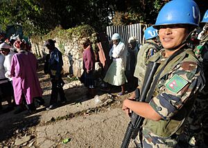 A United Nations Peacekeeper from Nepal provides security at a rice distribution site in Kenscoff, Haiti, Feb. 20, 2010 100220-N-HX866-010