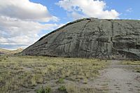 Large rounded rock rising above the plains