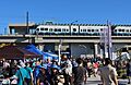 Western side of Lynnwood City Center Station on opening day with vendor booths and crowds in the foreground.