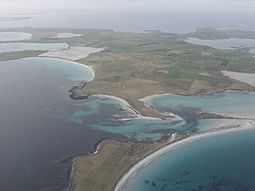 An aerial view of the southern coast of Sanday, looking west. Tres Ness and Conninghole are in the foreground.