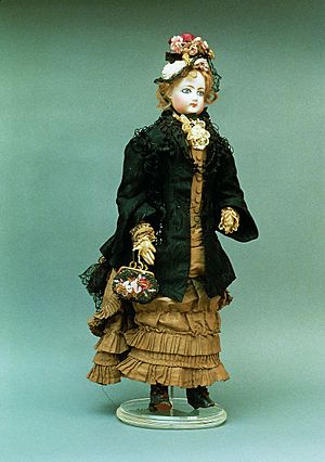 Porcelain doll in period dress. France, 1877