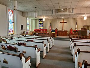 Sanctuary of Chesterville Community Church with altar and windows