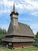 A wooden church with a pointy spire