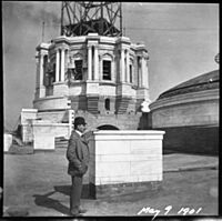 Cass Gilbert standing before partially completed Minnesota State Capitol dome