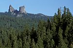 The Rabbit Ears, a pair of spires, rise above the coniferous forest of the Rogue River–Siskiyou NF.