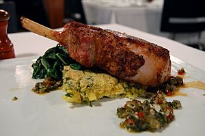 Spoonbread with pork chop and greens