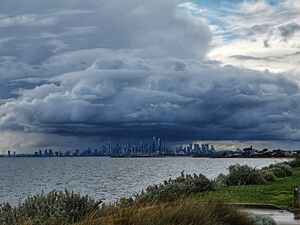 Storm clouds and blue sky over Melbourne skyline