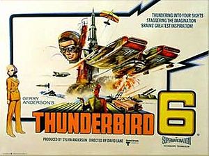 The words "Thunderbird 6" line the bottom edge of a poster which depicts a futuristic aircraft against the backdrop of a tower. The lower hull of this aircraft, resembling an airship of the future, is on fire. A small biplane flies overhead, while from the background the face of a man wearing flying goggles stares in the direction of the viewer.