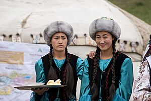Kyrgyz women offering butter and salt