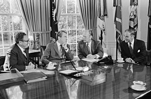 President Richard Nixon seated at his Oval Office desk during a meeting with Henry Kissinger, Alexander Haig, and Gerald Ford