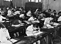School children doing exams inside a classroom (15727213731)