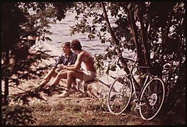 BICYCLING COUPLE STOP DURING THEIR TOUR OF FOURTH LAKE, NEW YORK, IN THE ADIRONDACK FOREST PRESERVE - NARA - 554494.jpg