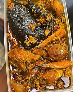 Egusi soup with vegetables and dried catfish, prawns, beef and roasted cowskin
