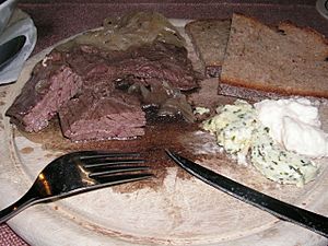 Kronfleisch (skirt steak), a traditional Bavarian dish often served with onion rings, rye bread, composed butter (with herbs and garlic) and horseradish