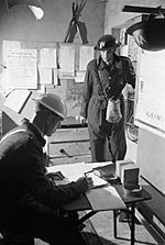 An Air Raid Precautions Warden reports for duty to the Chief Warden at his local ARP post in Springfield, Essex, aUGUST 1941. D4263