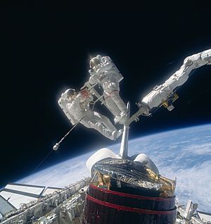 Astronauts Gardner and Allen on the RMS after recapture of Westar VI