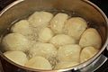 Pan of dumplings in boiling liquid