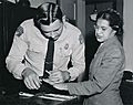 Rosa Parks being fingerprinted by Deputy Sheriff D.H. Lackey after being arrested for refusing to give up her seat for a white passenger on a segregated municipal bus in Montgomery, Alabama
