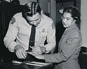 Rosa Parks being fingerprinted by Deputy Sheriff D.H. Lackey after being arrested for refusing to give up her seat for a white passenger on a segregated municipal bus in Montgomery, Alabama