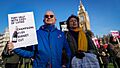 Protester with placard 'Tory help with cost of living - Champagne £1.60 budget cut.'