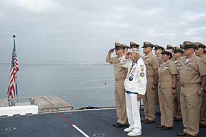 Stu Hedley, a retired Navy Chief Petty Officer, salutes the ensign during colors with the Chief's Mess. (25960465960)