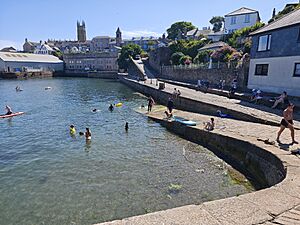 Abbey Slip full with people swimming and paddleboarding in Penzance