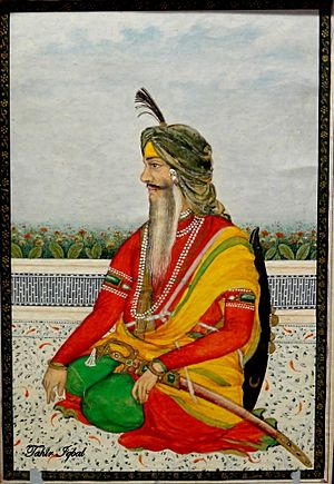 Miniature painting of a seated Raja Tej Singh with a sword on his lap and shield on his back.jpg